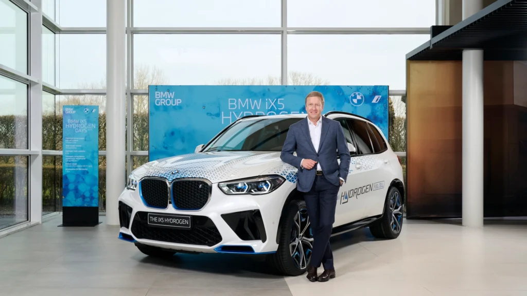 BMW Chairman Oliver Zipse stands next to the new BMW iX5 Hydrogen Fuel Cell vehicle