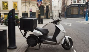 Electric moped charging on the street in London. (Image: Alamy)