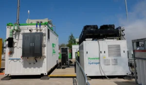 The GeoPura HPU2 Hydrogen Power Generator (Right) with visible water vapour from live testing, next to its predecessor, the HPU1.