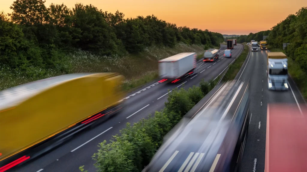 Heavy traffic moving at speed on UK motorway in England at sunset. (Image: iStock)