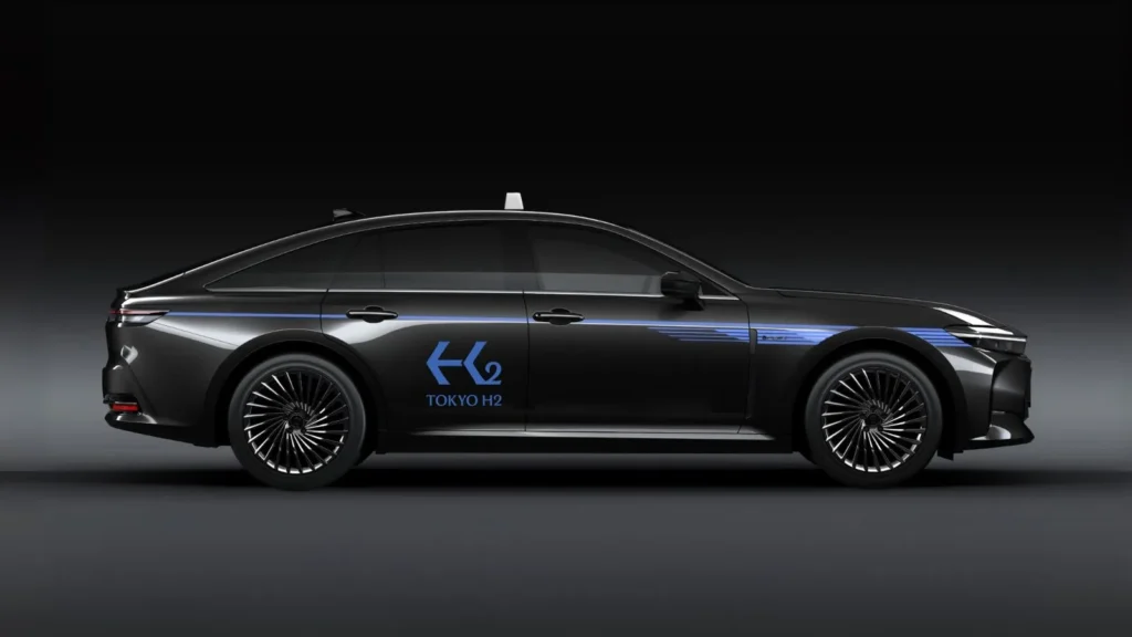 Side view of a black Toyota Crown hydrogen taxi with H2 Tokyo livery and aerodynamic styling.