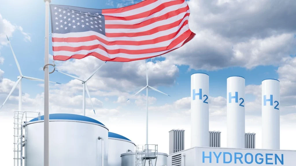 American flag flying over a hydrogen facility and wind turbines amid clean energy funding cuts in the United States