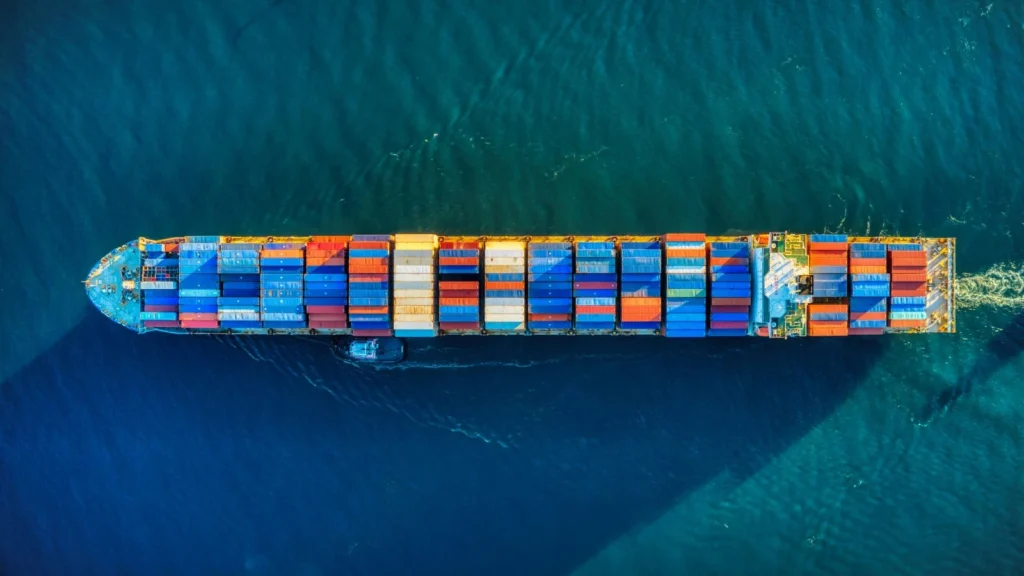 Aerial view of cargo ship at sea, representing clean hydrogen fuel for maritime shipping