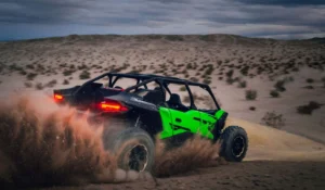 Rear view of Kawasaki Teryx H2 kicking up sand across the desert floor