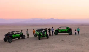 Three Kawasaki Teryx H2 hydrogen off-roaders parked at sunset overlooking desert landscape