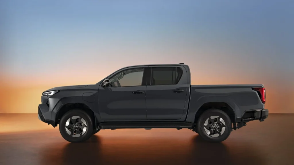 Side profile of the Toyota Hilux BEV Double Cab showing its strong lines and charging port
