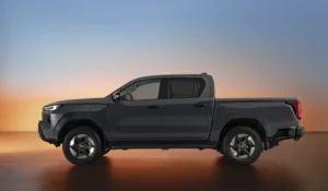 Side profile of the Toyota Hilux BEV Double Cab showing its strong lines and charging port