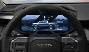 Steering wheel and digital cockpit of the Toyota Hilux BEV showing Multi-Terrain Select modes