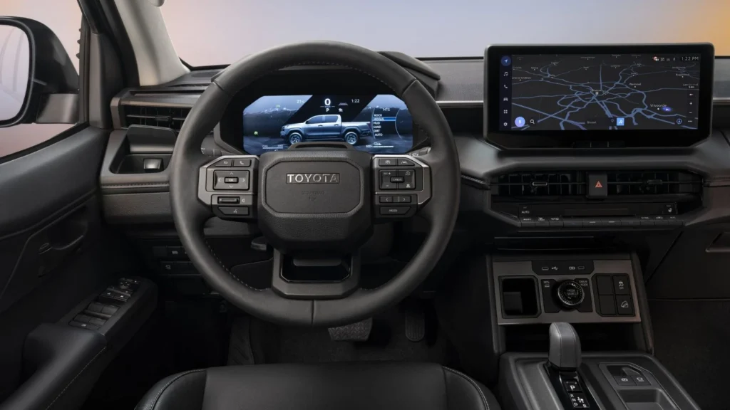 Interior view of the Toyota Hilux BEV dashboard and steering wheel with large central display