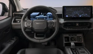 Interior view of the Toyota Hilux BEV dashboard and steering wheel with large central display