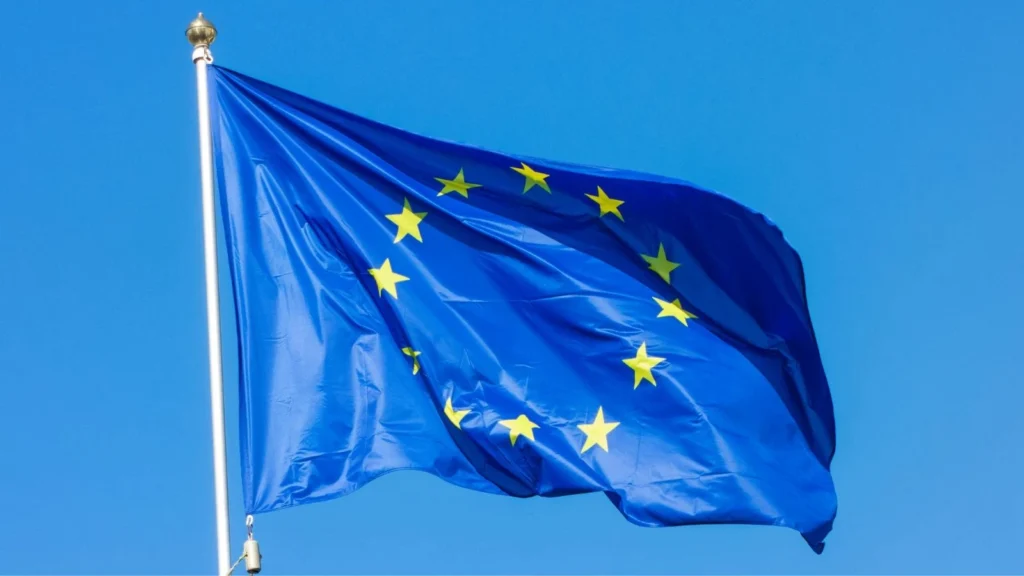 European Union flag flying in front of bright blue sky