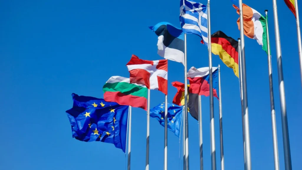 European Union flags flutter in the wind representing the seven Member States involved in the €1.4 billion hydrogen IPCEI Hy2Move project, focused on decarbonising mobility and transport.